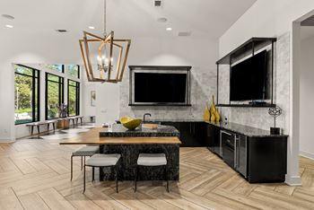 A modern kitchen with a black countertop and a large island. at Preserve at Rolling Oaks, Austin, TX, 78728